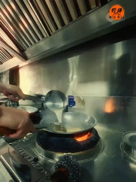 Kitchen production client work: a wok over an open flame